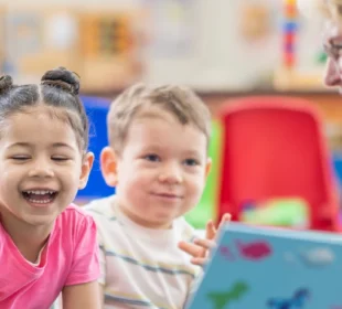 Woman reading book to children