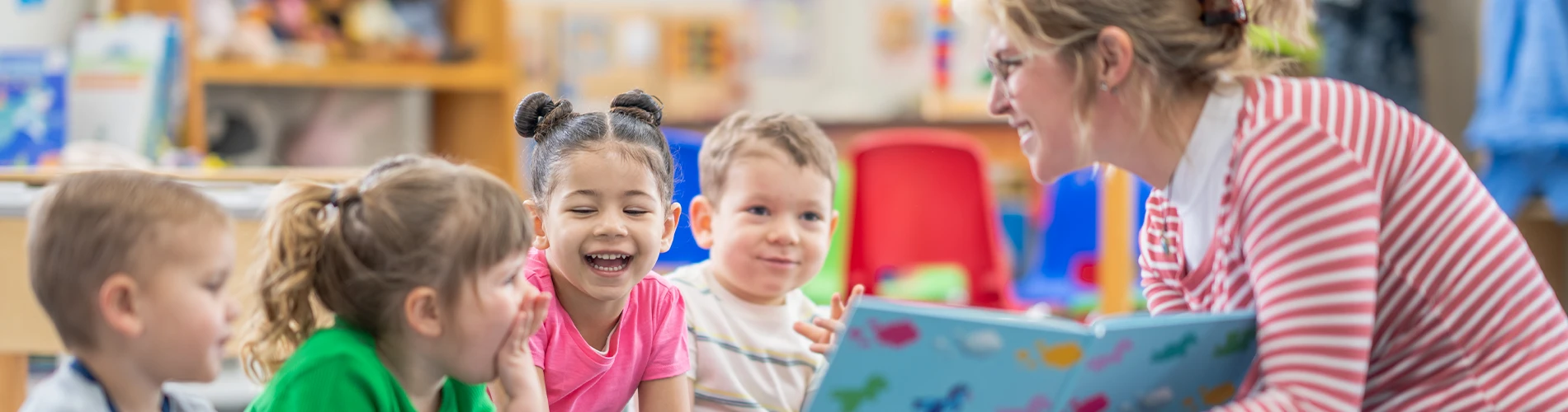 Woman reading book to children