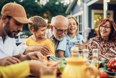 Multigenerational family eating outside