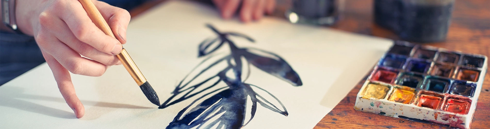 woman's hand painting on paper