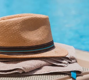 Hat and towel at the edge of a pool