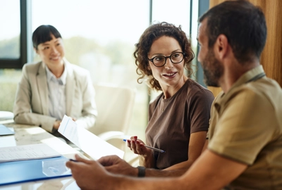 Couple talking about contract on a meeting with their advisor.