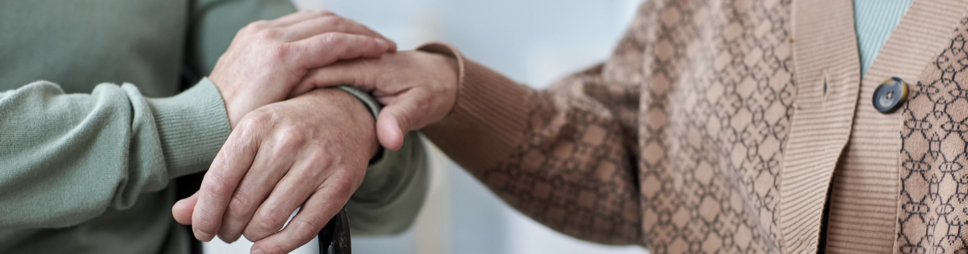 Close up of senior couple holding hands during therapy session