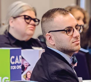 people listening to a speaker at an IIF event