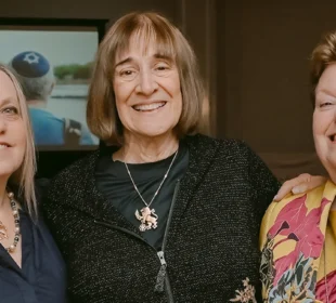 women smiling at an event