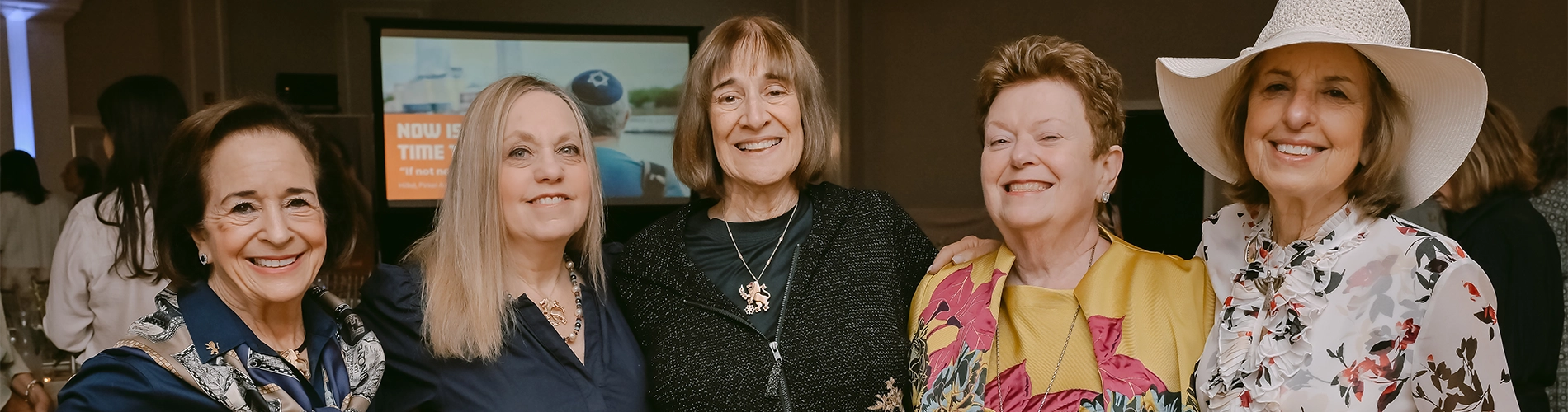 women smiling at an event